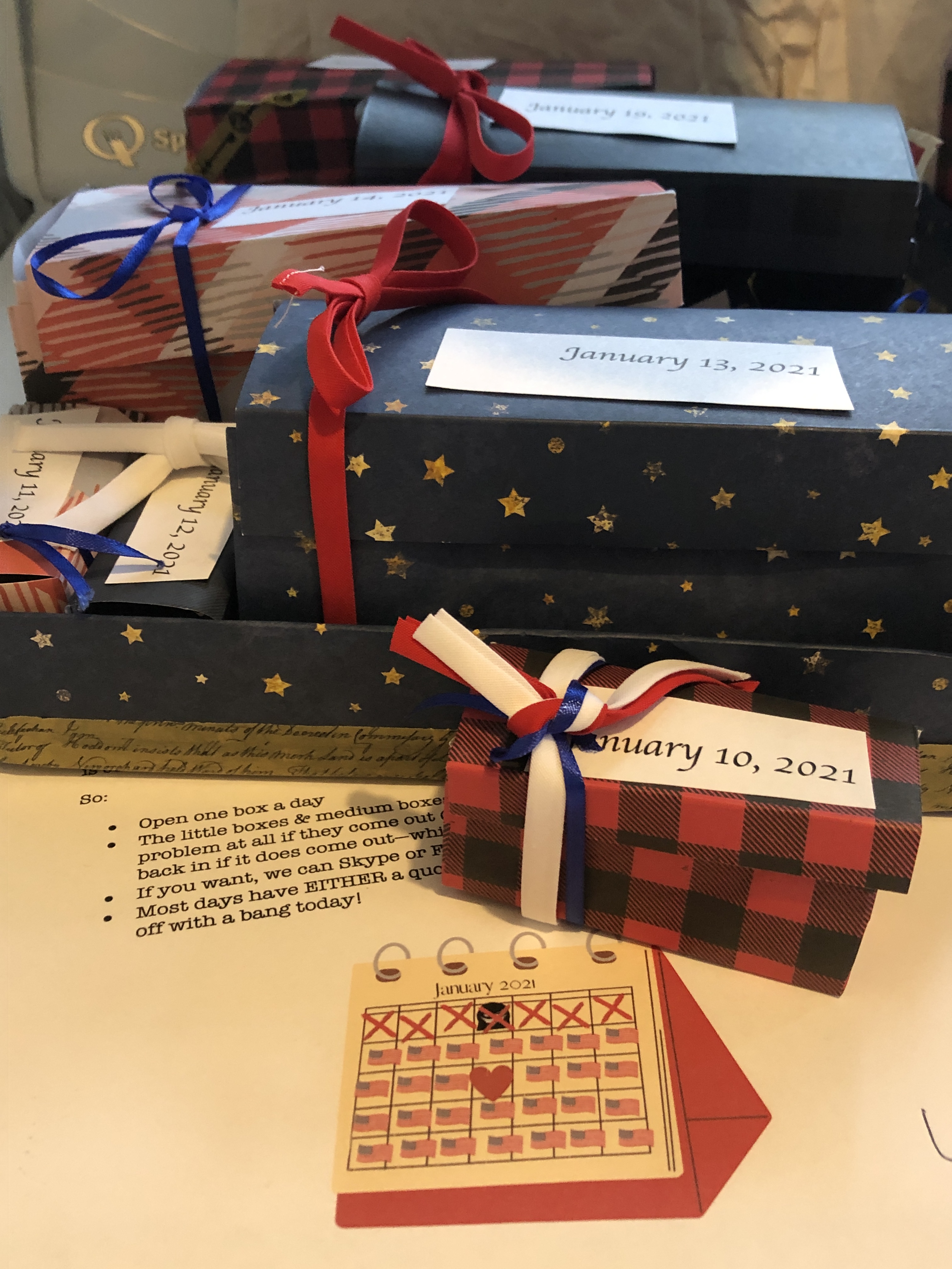 picture of boxes made of paper with dates on them, tied with ribbon 
