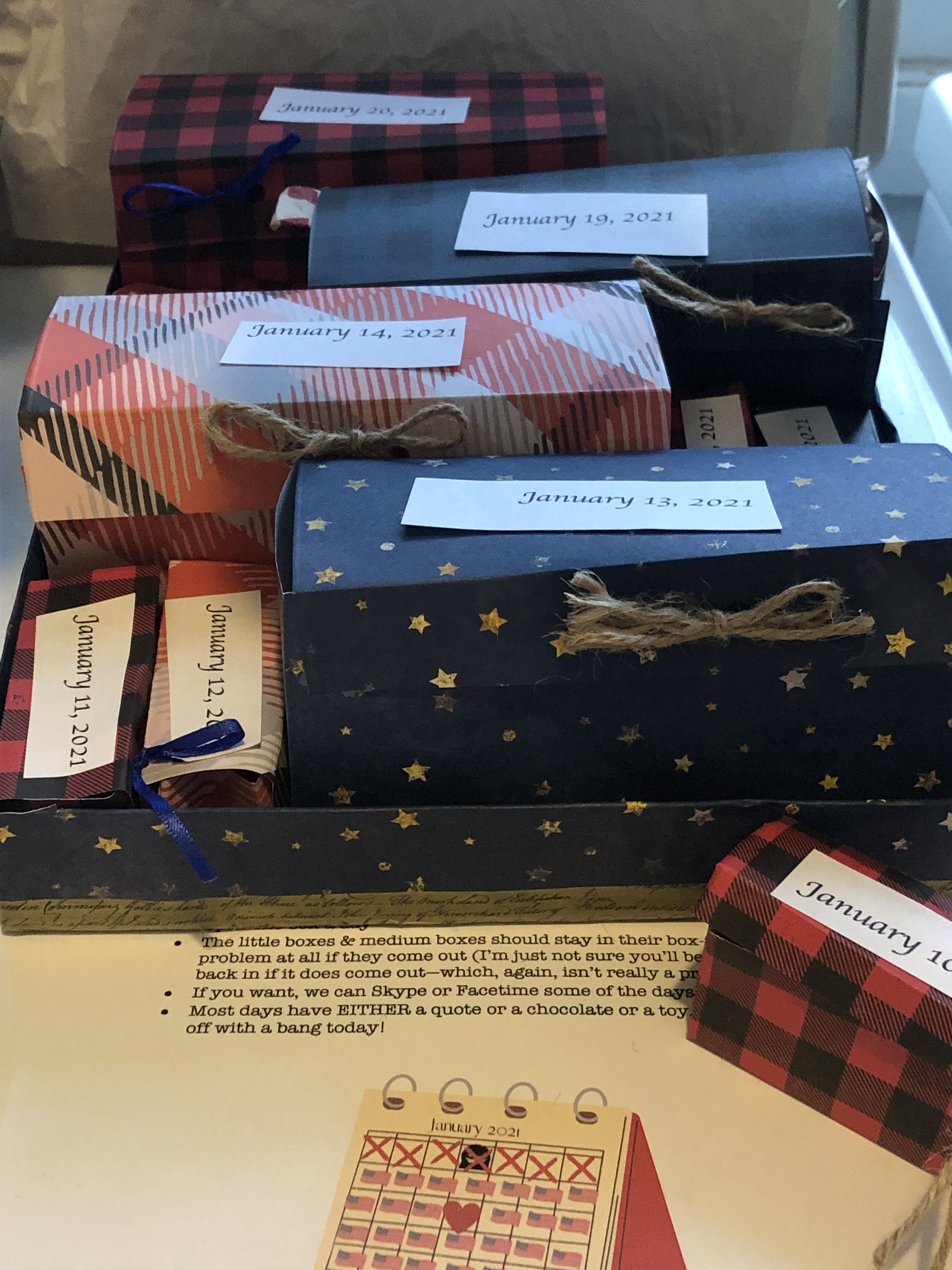 boxes made of paper with the date on them, closed with twine or ribbon